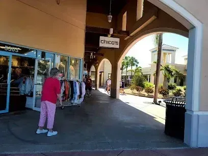 Hvac-Contractor-Bradenton-A woman in a red shirt is standing in front of a store.