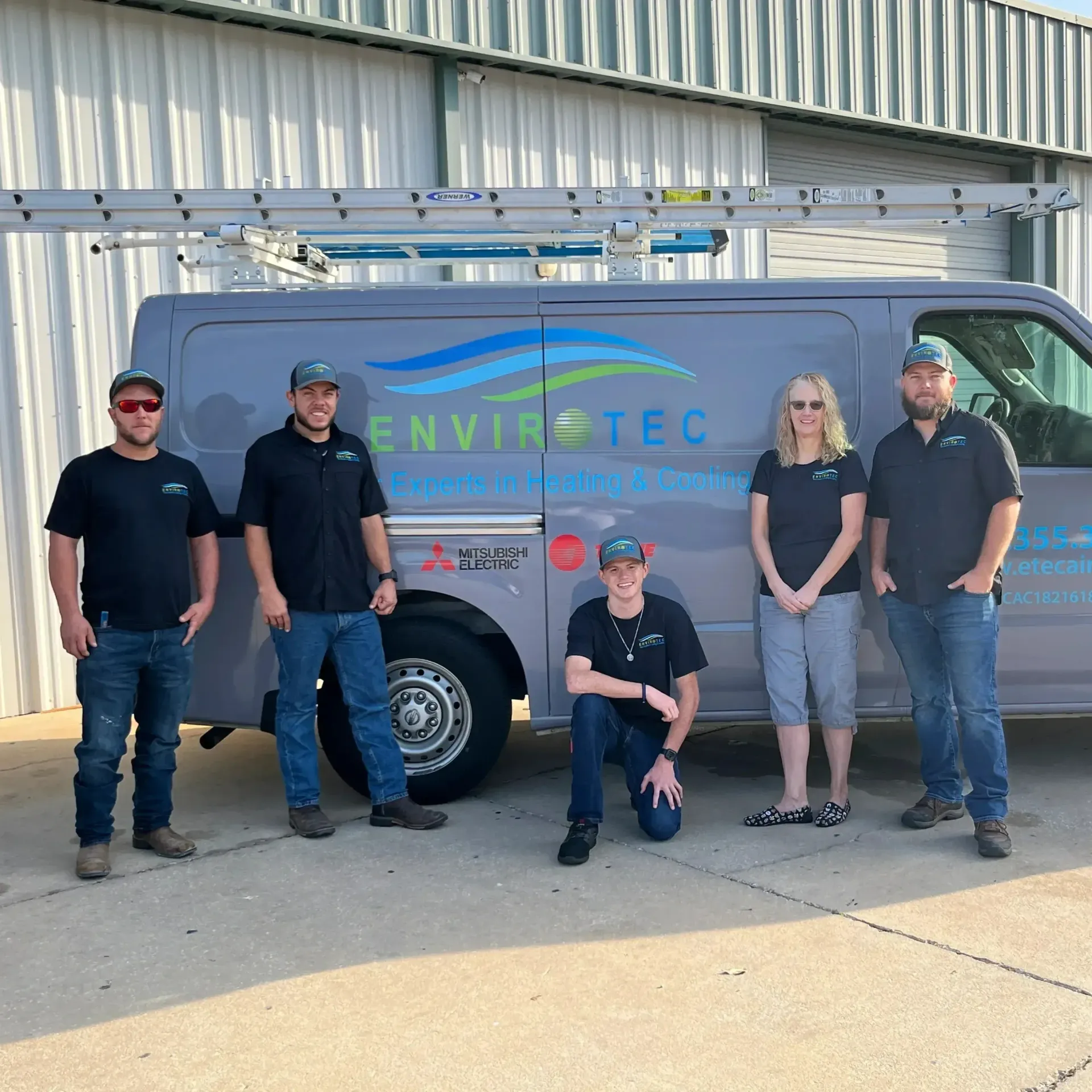 Hvac-Contractor-Bradenton-A group of people standing in front of a van that says envirotec