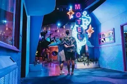 Hvac-Contractor-Bradenton-A man and a woman are dancing in a room with neon lights.