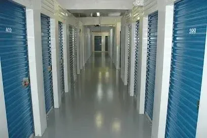 Hvac-Contractor-Bradenton-A long hallway with blue shuttered doors in a storage facility