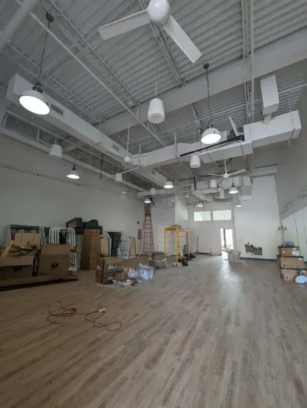 Hvac Contractor Bradenton - A large empty room with wooden floors and ceiling fans.