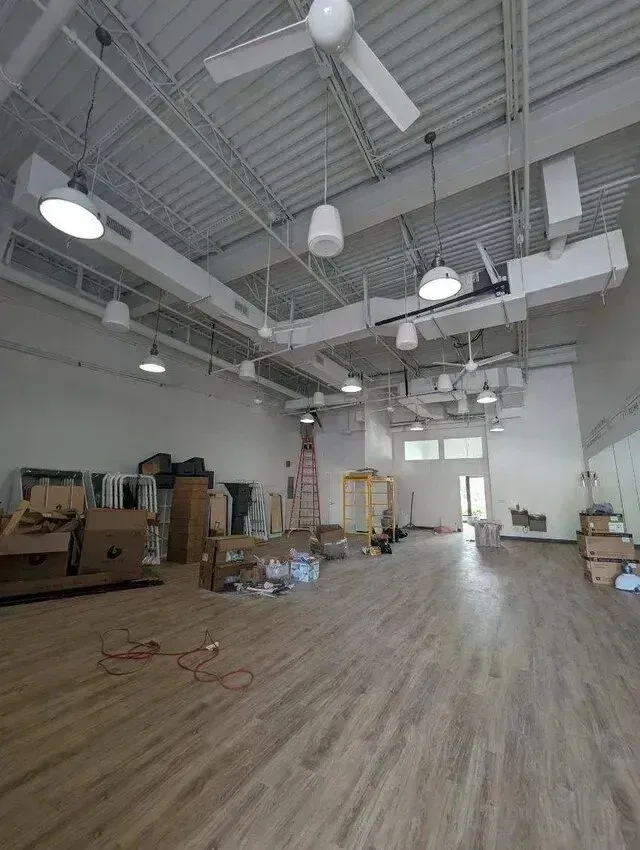 Hvac Contractor Bradenton - A large empty room with wooden floors and ceiling fans.