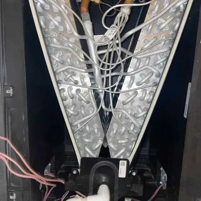 Hvac Contractor Bradenton - the inside of an air conditioner with a lot of wires coming out of it
