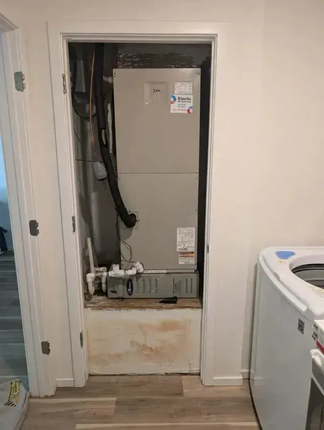 Hvac Contractor Bradenton - An air conditioner is installed in a closet next to a washer and dryer.