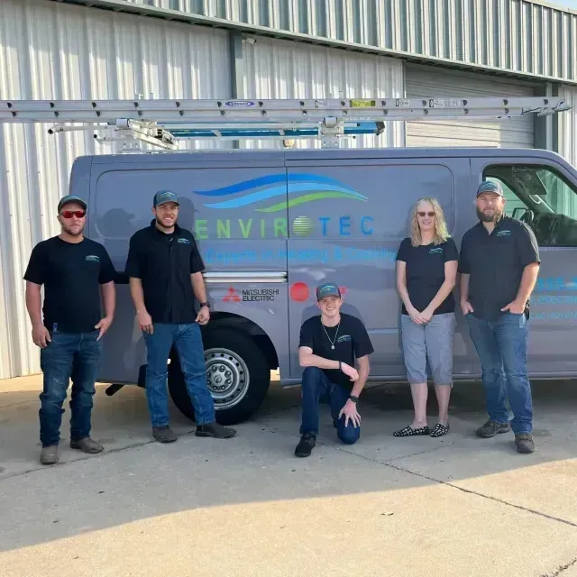 Hvac Contractor Bradenton - a group of people standing in front of a van that says envirotec