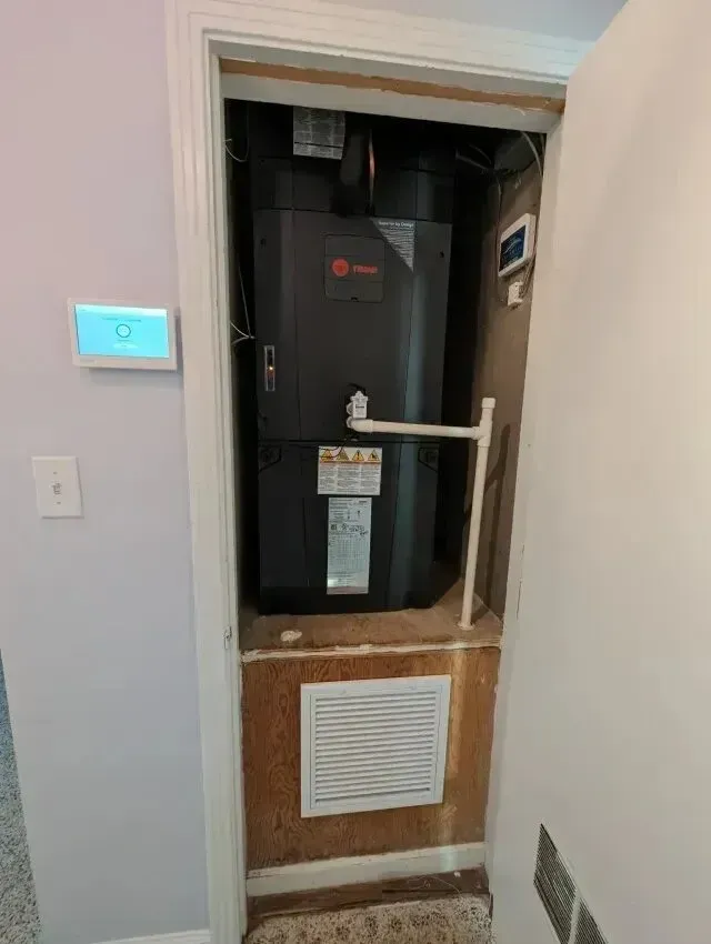 Hvac Contractor Bradenton - A black air conditioner is sitting inside of a closet.