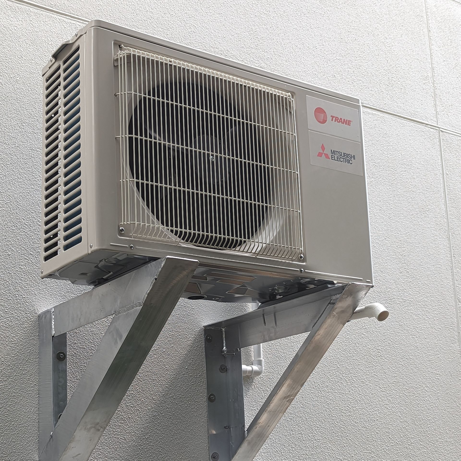 a mitsubishi air conditioner is mounted to a wall