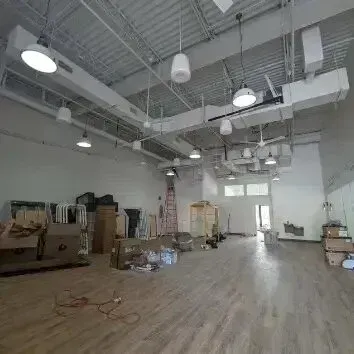 Hvac-Contractor-Bradenton-A large empty room with wooden floors and lots of boxes.