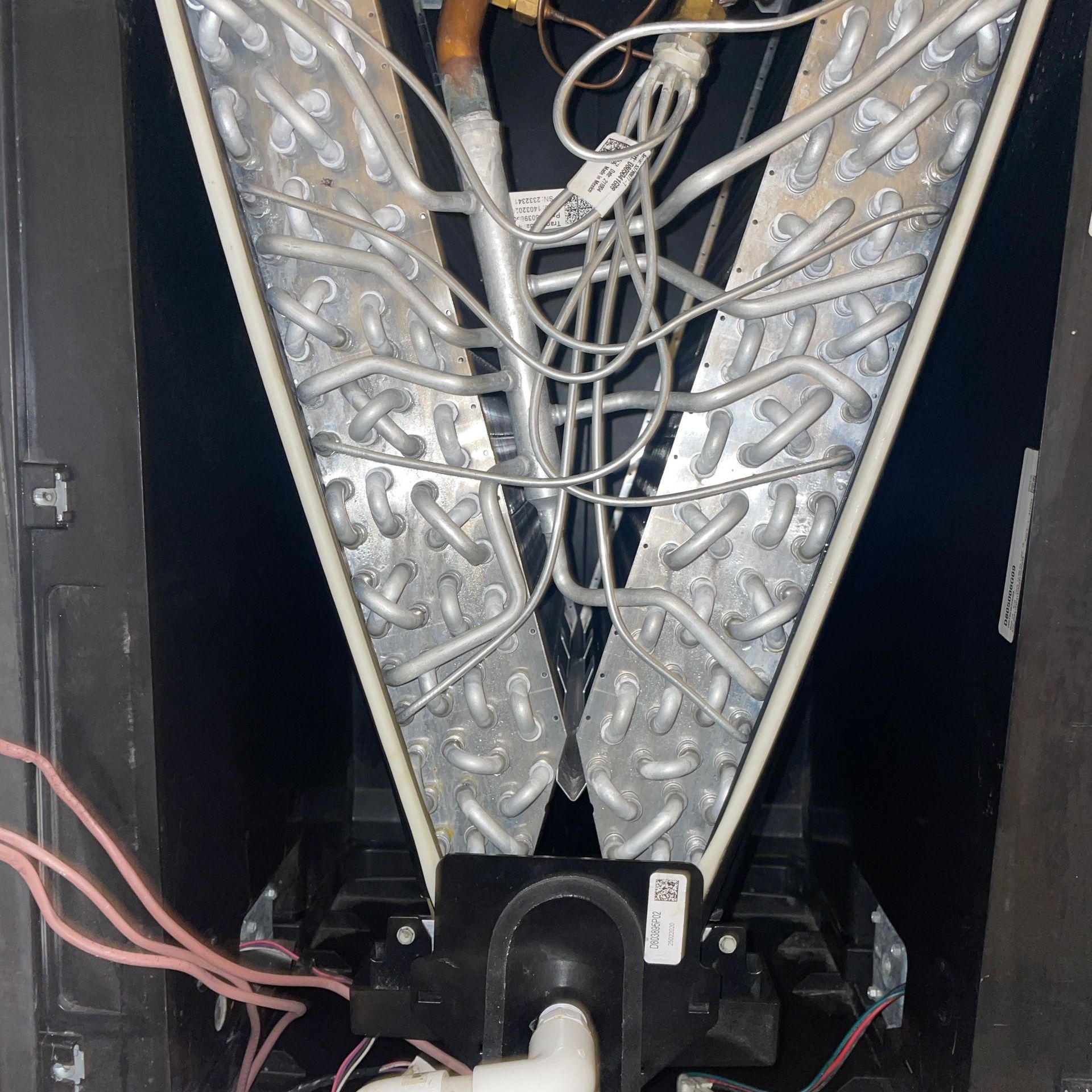 the inside of an air conditioner with a lot of wires coming out of it