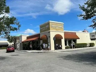 Hvac-Contractor-Bradenton-A group of people are standing outside of a restaurant on a sunny day.