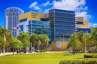 Hvac-Contractor-Bradenton-Tampa Bay History Center building in Florida, surrounded by green trees and grass, under a blue sky.