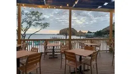 Hvac-Contractor-Bradenton-A patio with tables and chairs overlooking the ocean.