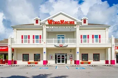 Hvac-Contractor-Bradenton-A large white building with a red sign that says wing houses