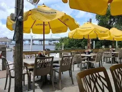 Hvac-Contractor-Bradenton-A restaurant patio with tables and chairs and yellow umbrellas.
