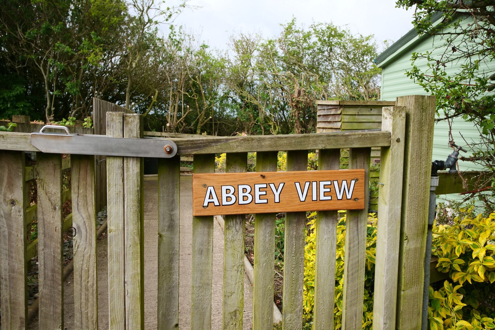 A wooden fence with a sign that says abbey view