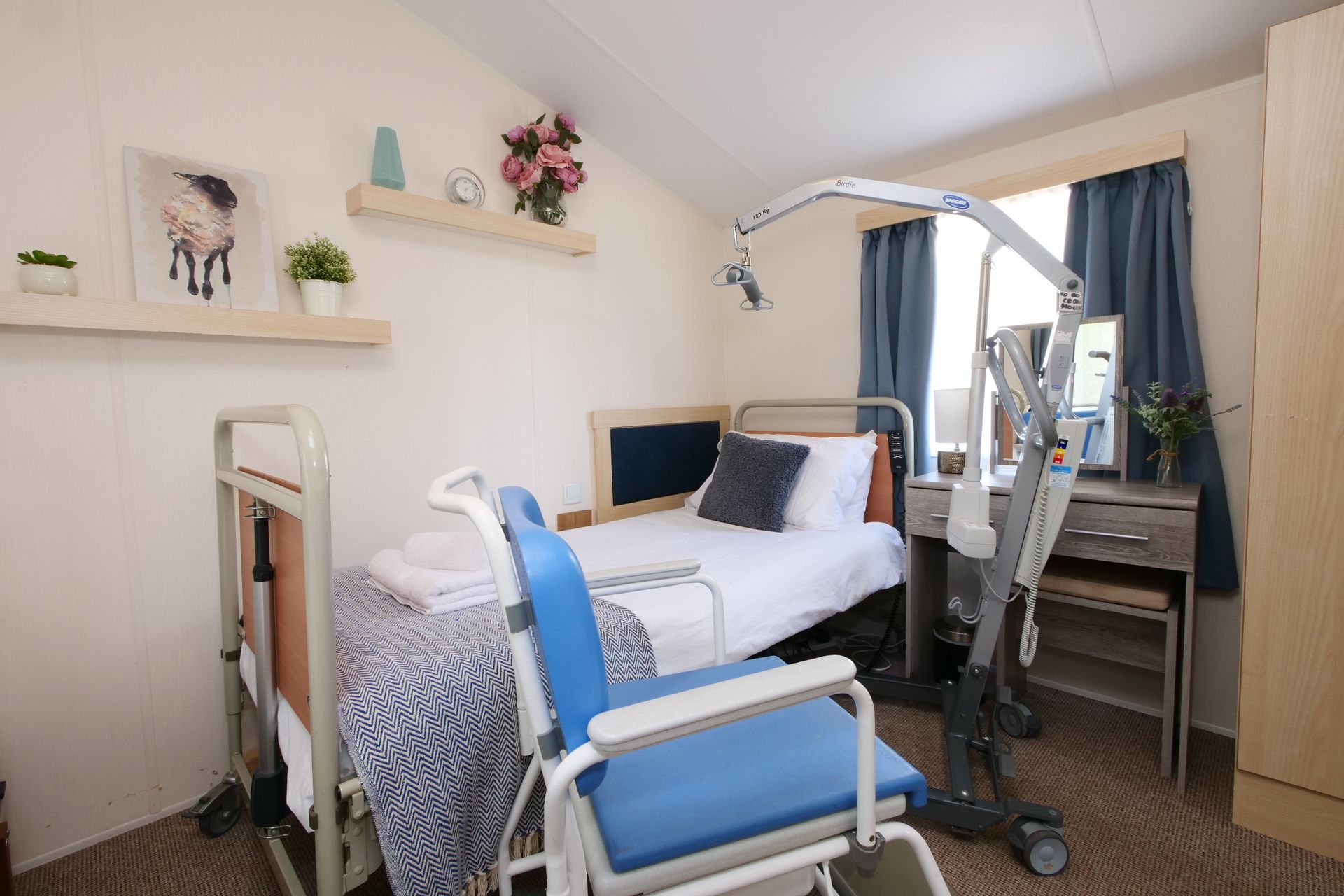 A hospital room with a bed and a wheelchair.