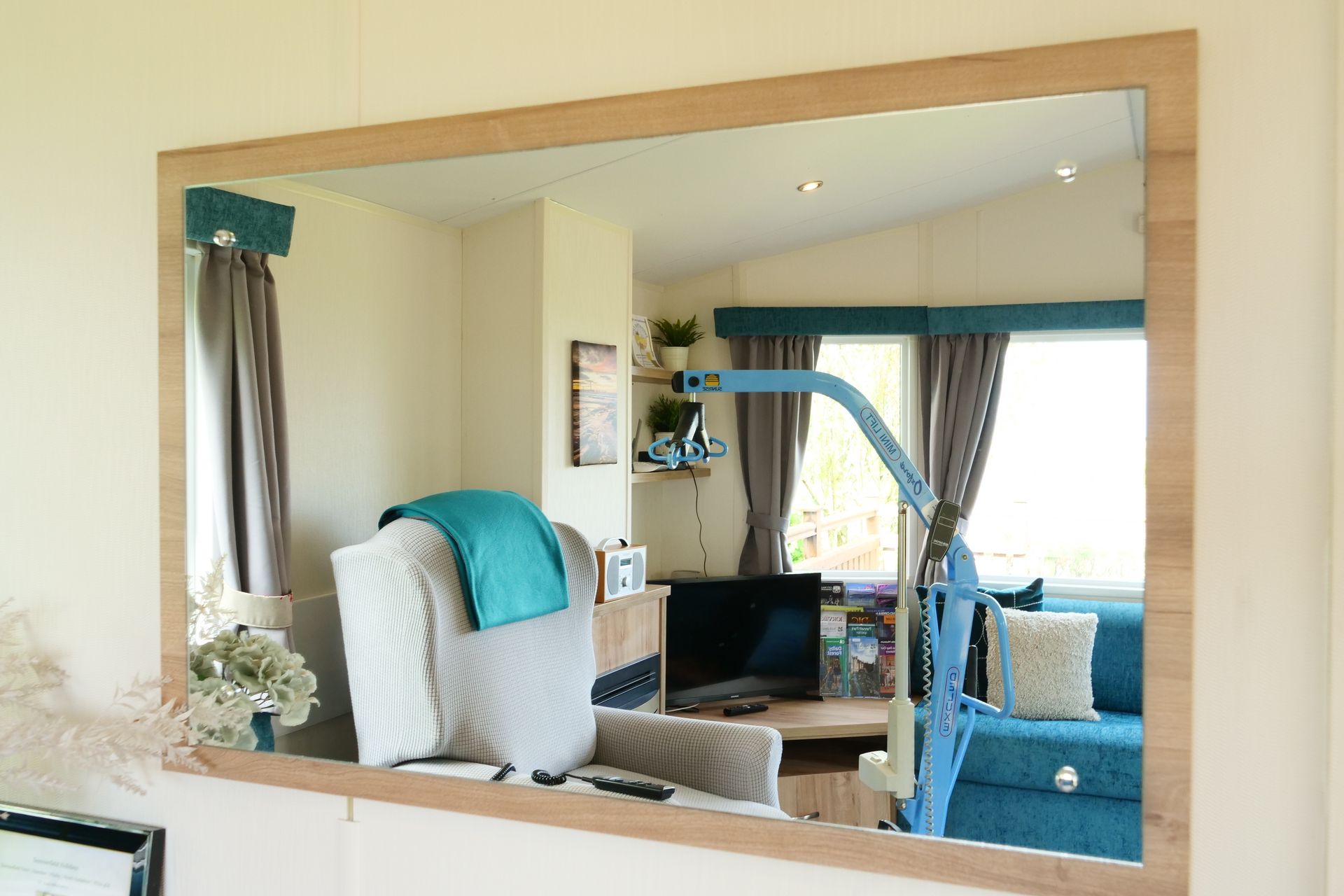 A living room with a large mirror hanging on the wall.