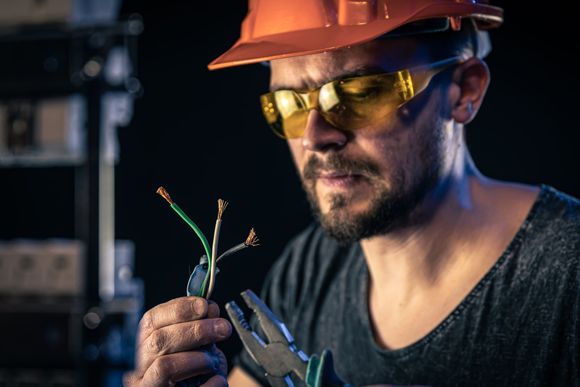 Stetson and Sons electrician inspecting wires