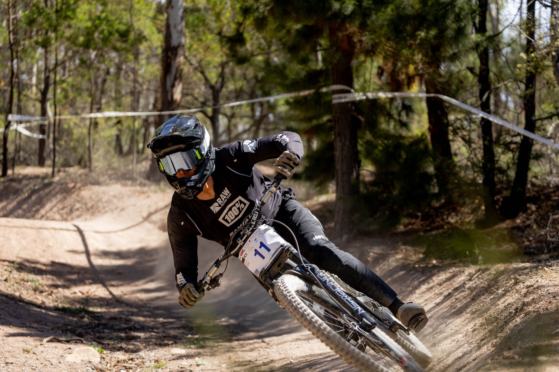 A person is riding a mountain bike down a dirt road.