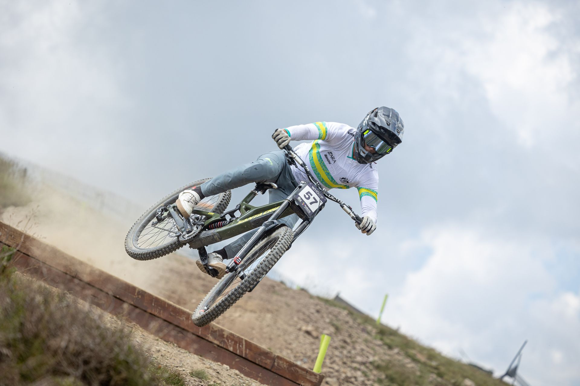 A man is riding a mountain bike down a dirt track.