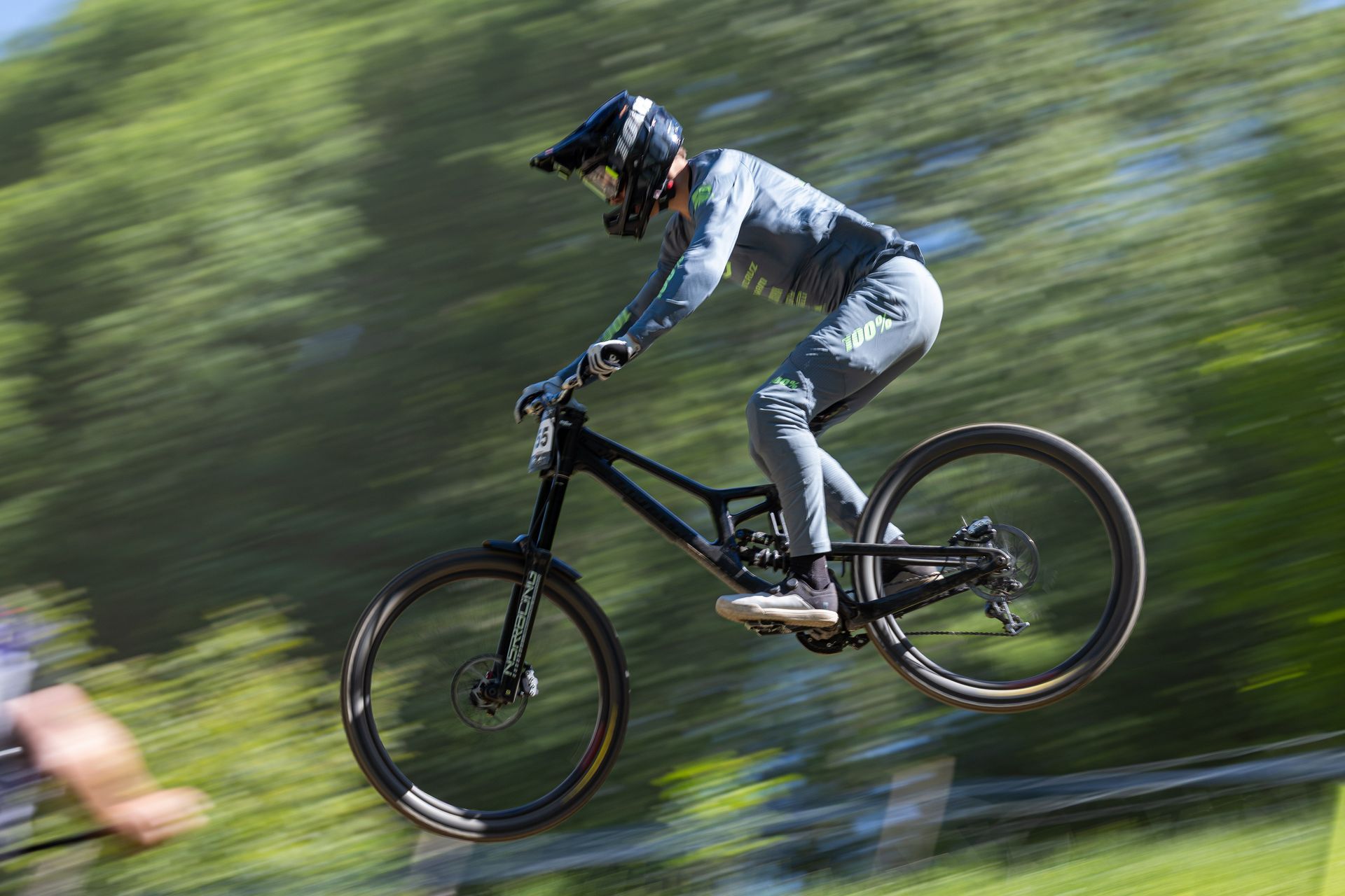 A person is riding a mountain bike down a hill.