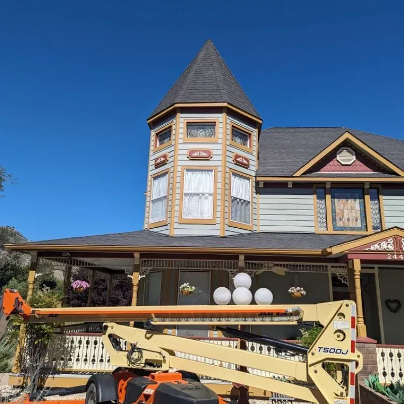 A large house with a crane in front of it