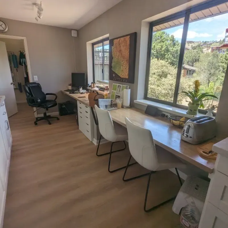 A room with a desk and chairs and a toaster