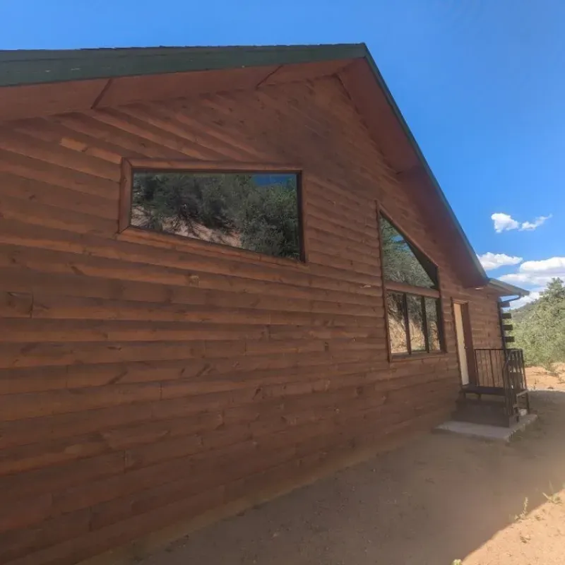 A wooden house with a blue sky in the background