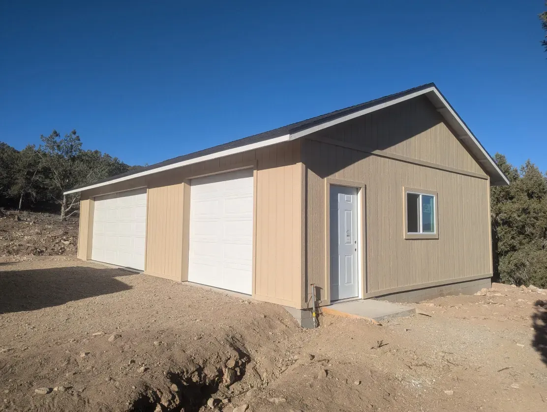 A garage with three garage doors and a window