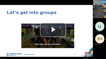 A video is being played on a screen that says let 's get into groups