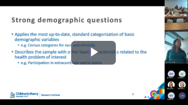 A woman is giving a presentation on strong demographic questions