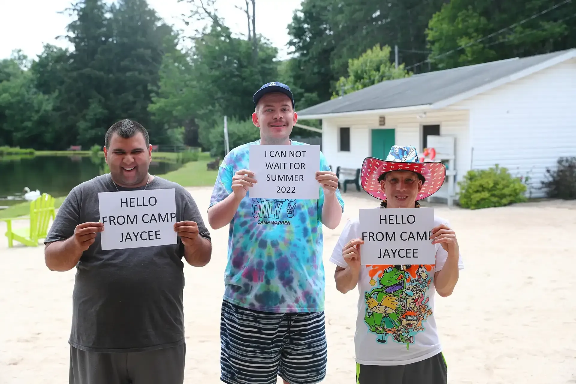 Three people holding signs that say 