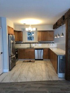 A kitchen with wooden cabinets and stainless steel appliances.