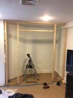 A ladder is sitting in the middle of a room.