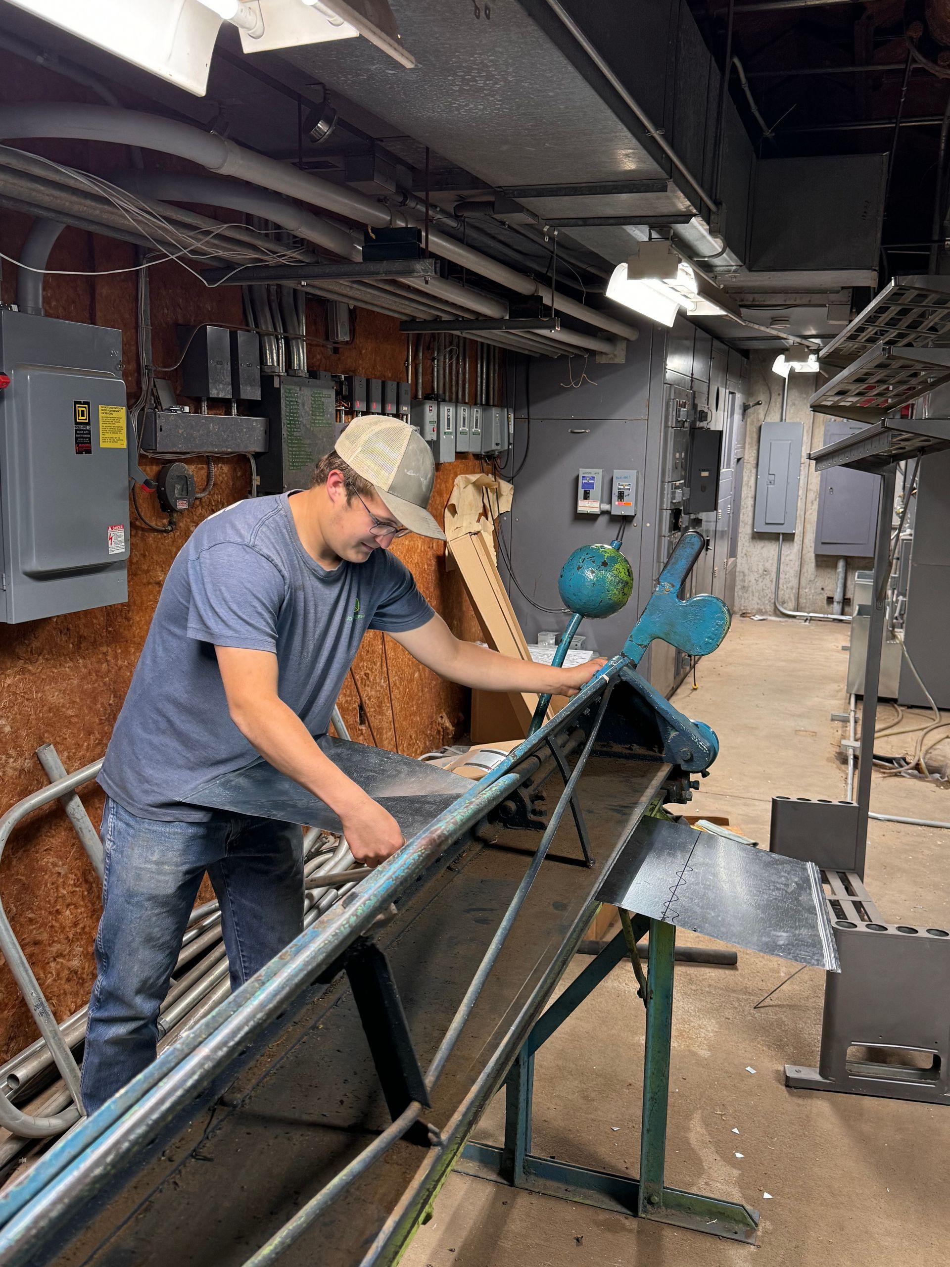 A woman is sitting at a desk using a laptop computer.