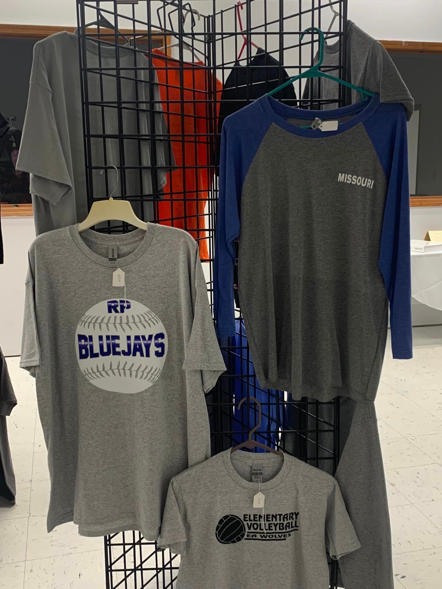 A blue jays t-shirt is hanging on a rack