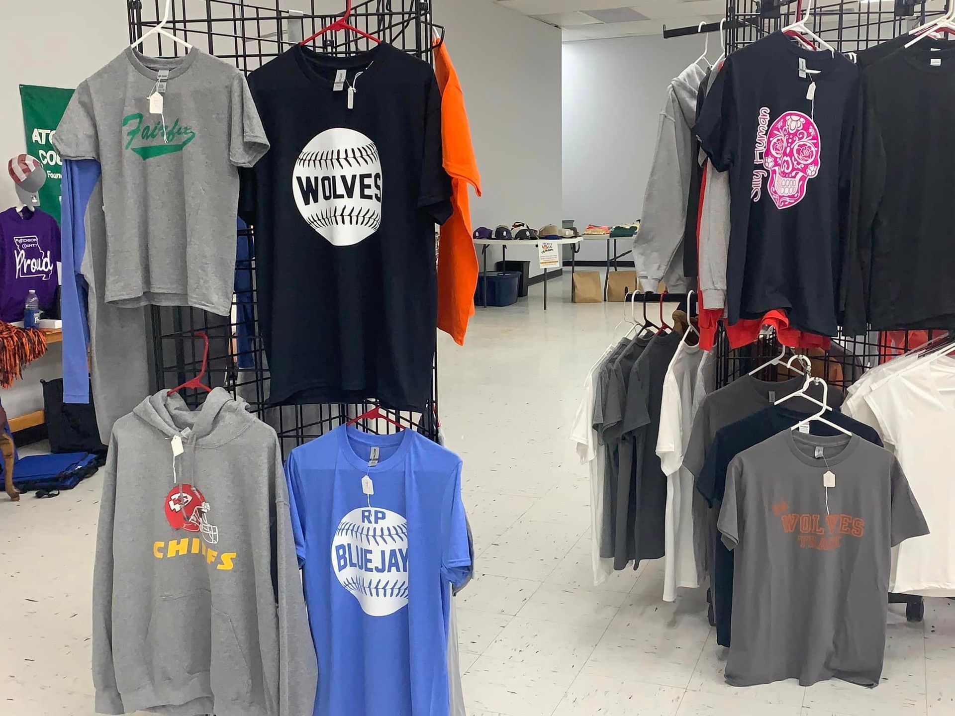 A store filled with lots of shirts including one that says wolves