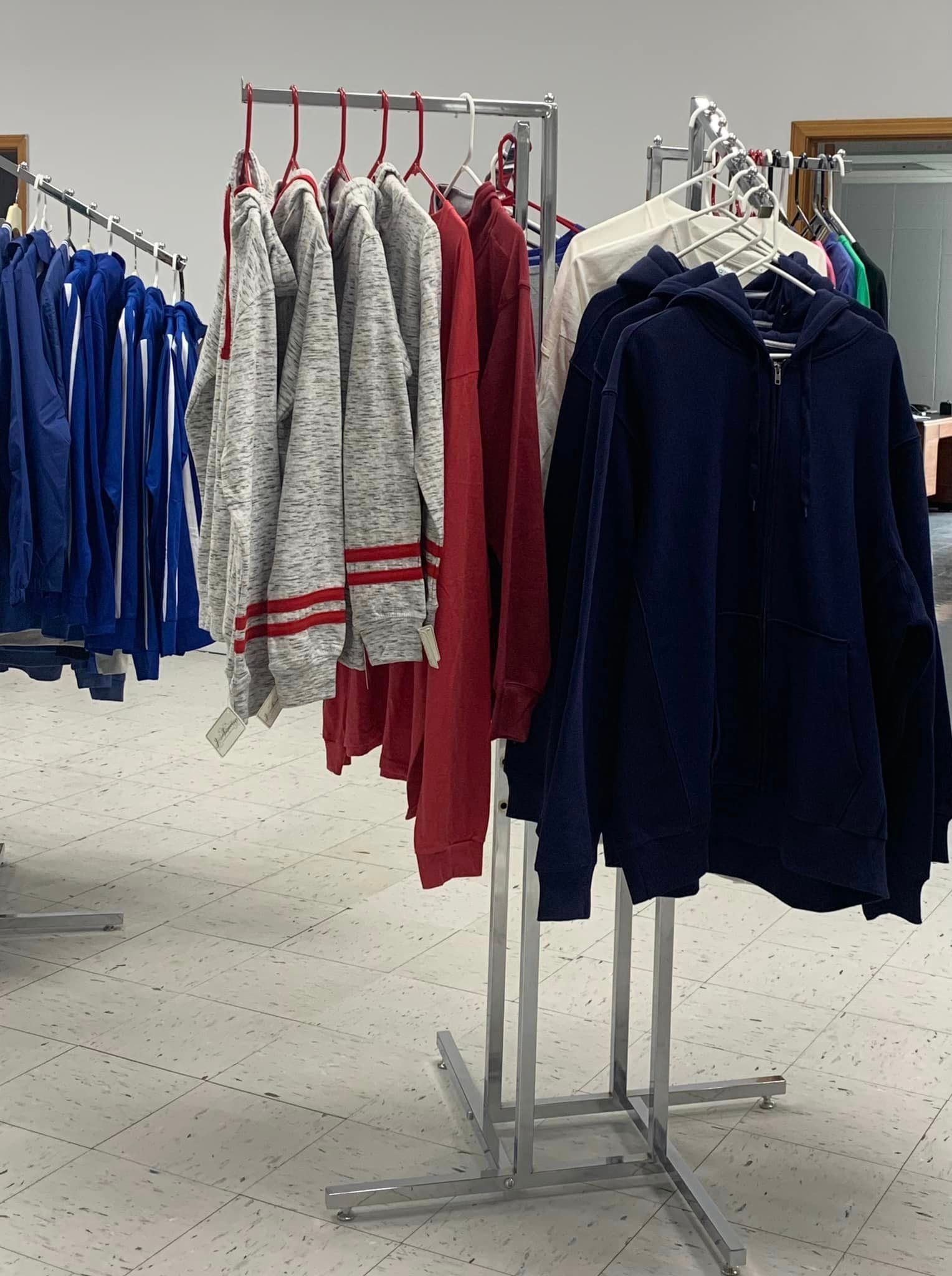 A bunch of clothes are hanging on racks in a store