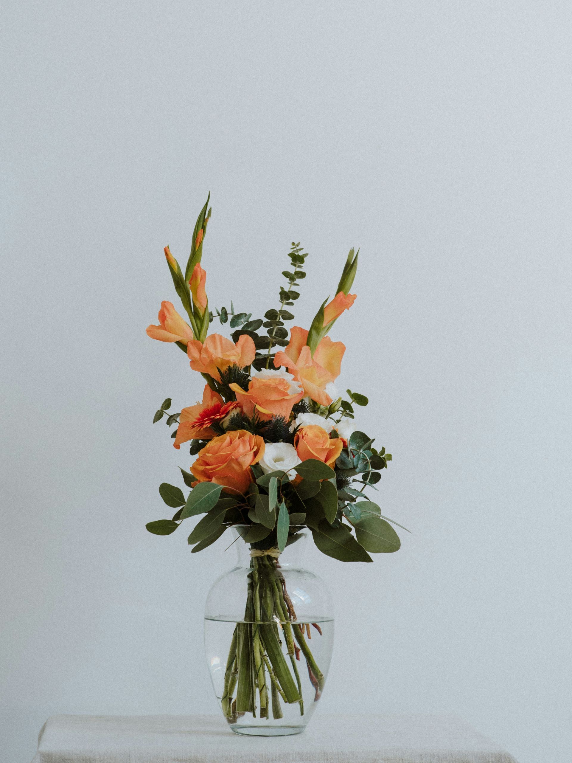 A vase filled with flowers is sitting on a table.