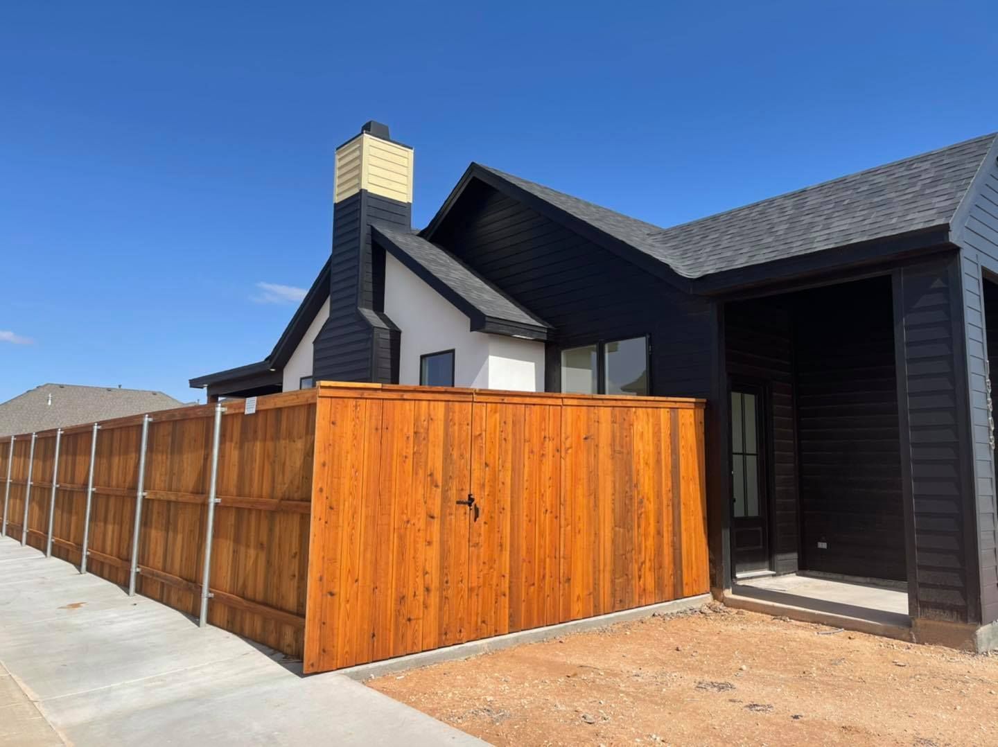 Black Modern House with Wooden Fence — Lubbock, TX — Hudson Fence Company