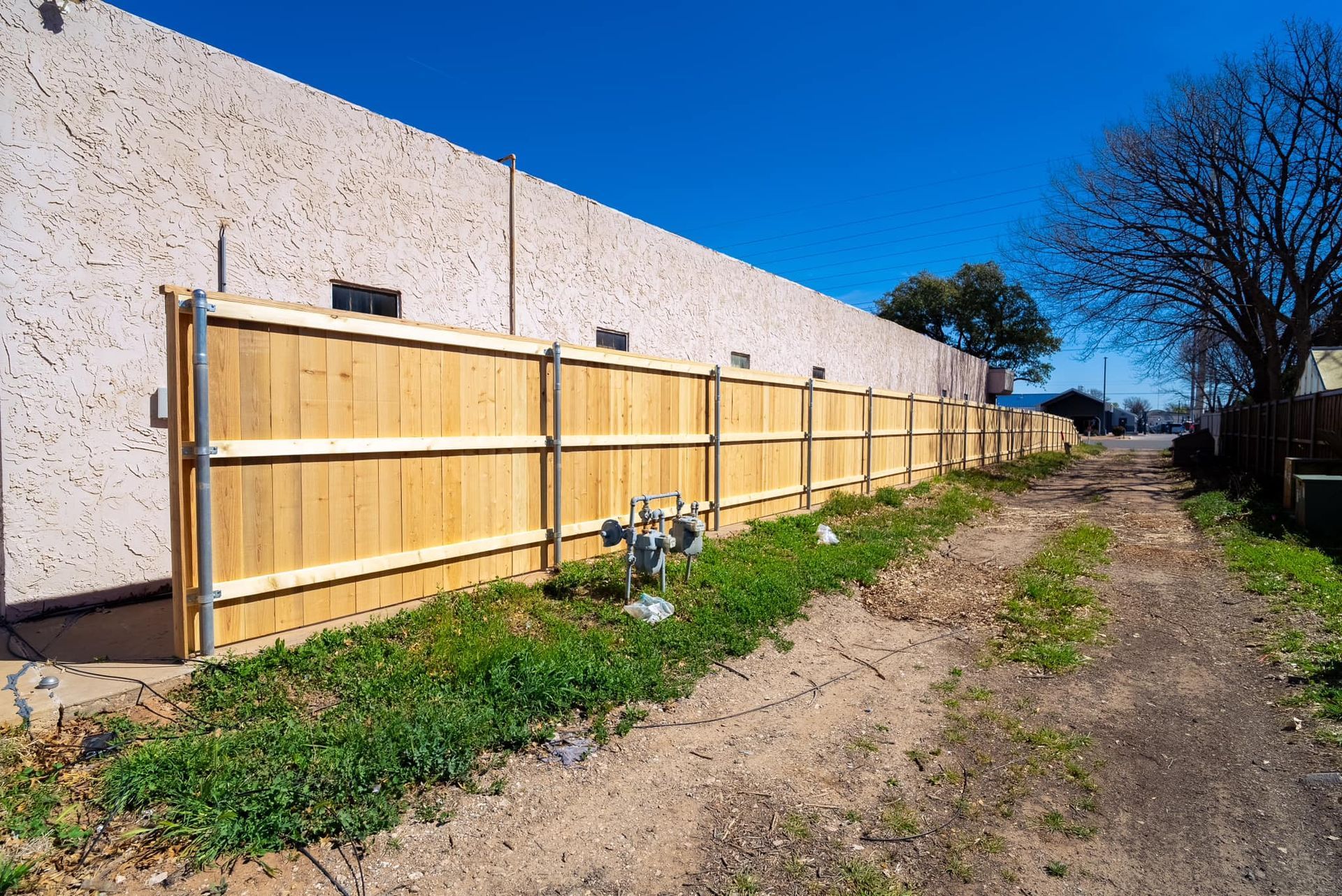 Man with Hat Repairing the Fence — Lubbock, TX — Hudson Fence Company