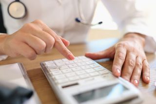 Doctor using calculator - Pine Bush, NY - JPM Bookkeeping Services