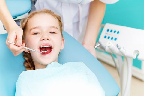 a girl getting tooth decay treatment