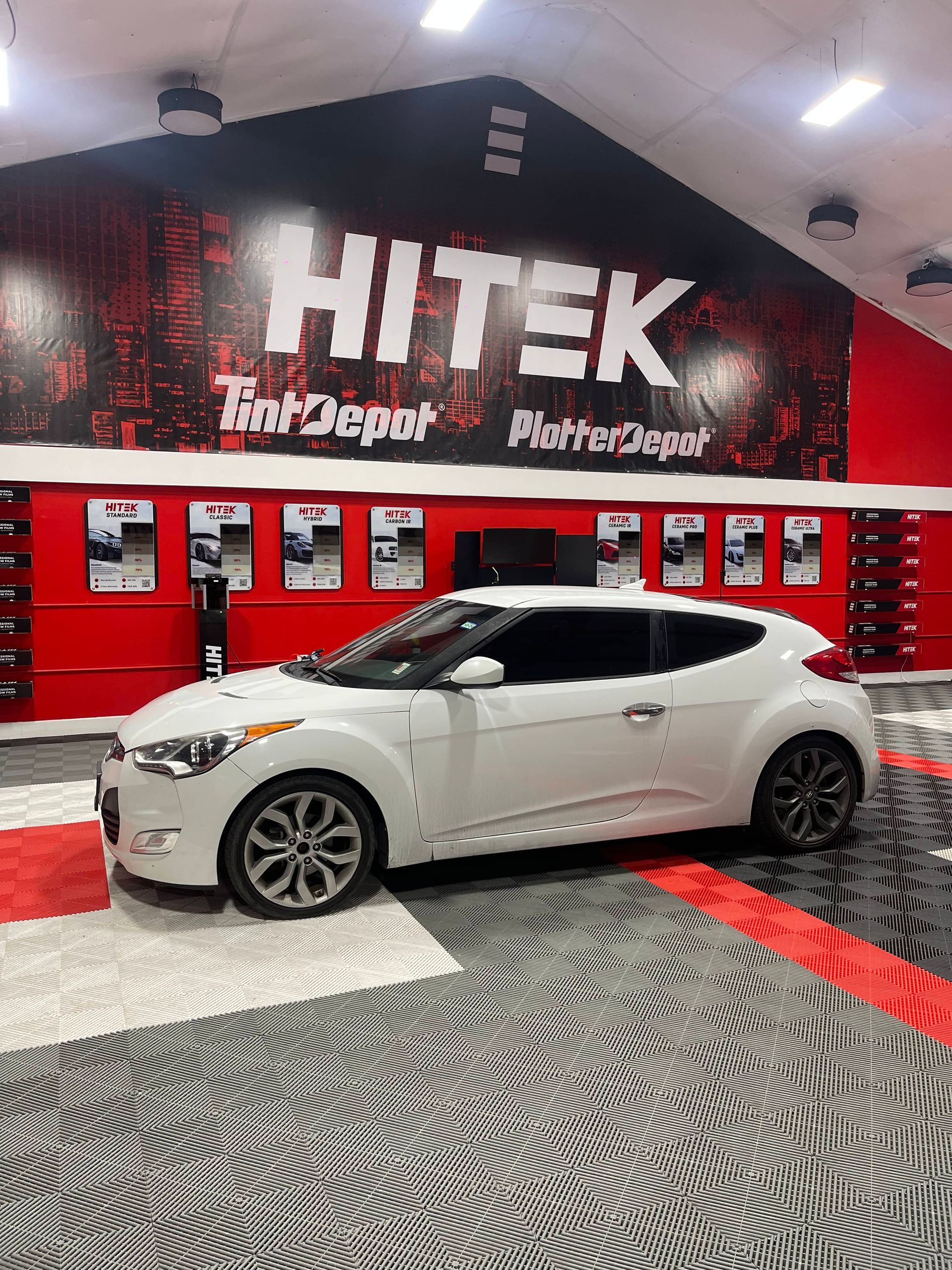 White Hyundai Veloster in front of 