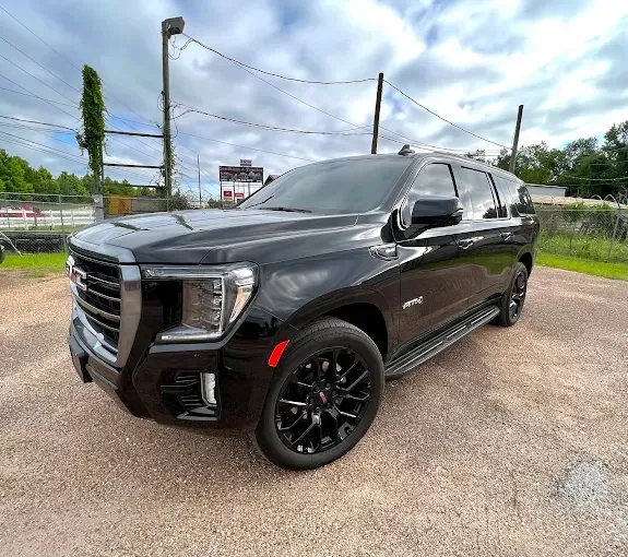 Black GMC Yukon SUV parked outside.