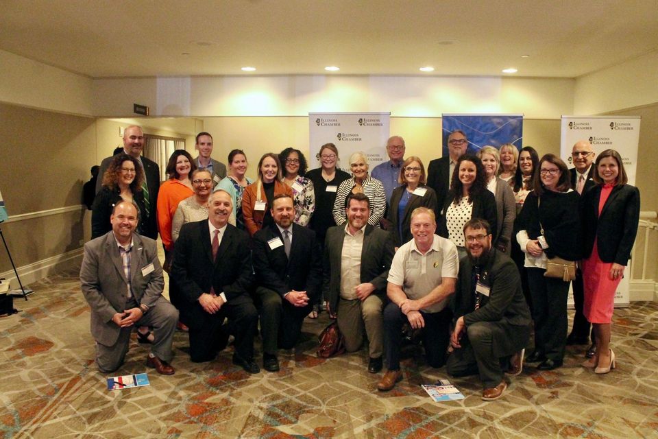 A group of people are posing for a picture in a room.