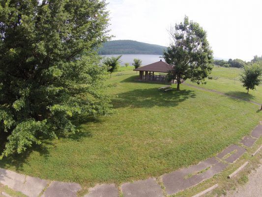 An aerial view of a park with a gazebo and trees.