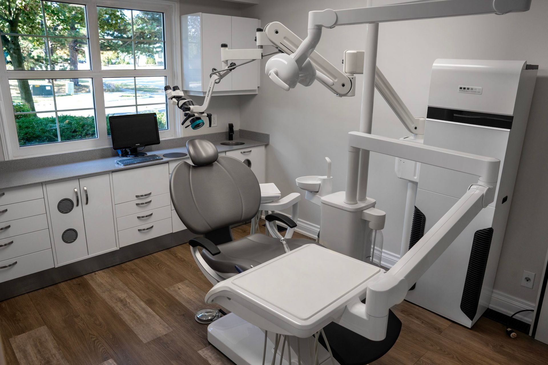 a dental office with a microscope and a computer | Bloor Street Dental | Best Family and Cosmetic Dentist In Mississauga For Implants, Braces, and Invisalign