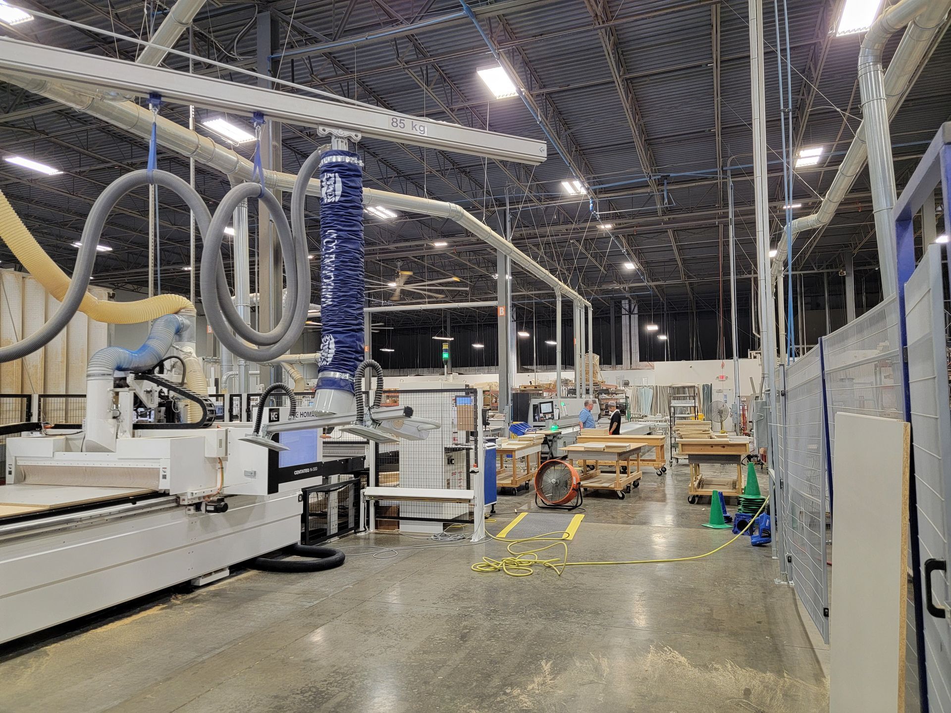 The Closets by Design 
warehouse with a lot of machinery in it.