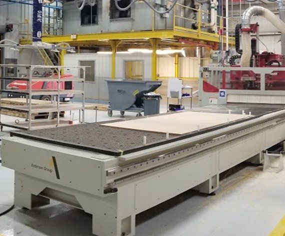 a large CNC machine is sitting in a factory .